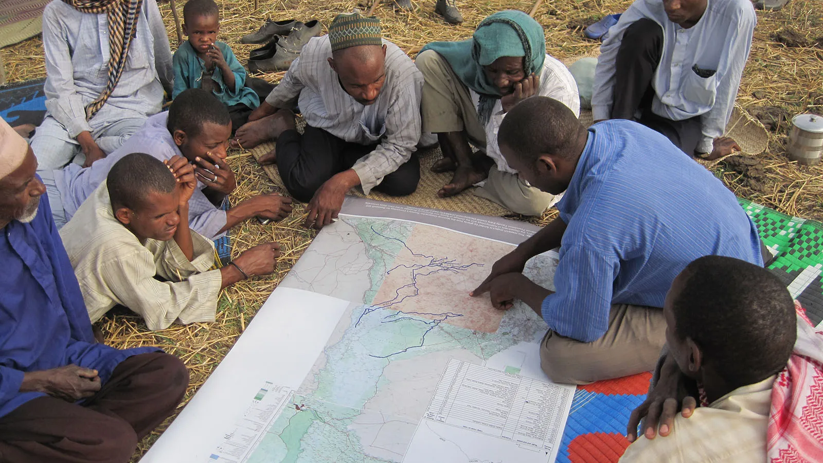 Researcher goes over maps with locals.